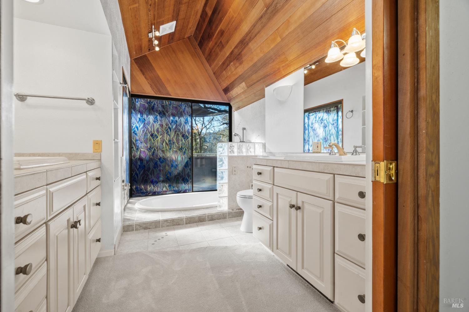 9105 Loch Haven Drive Santa Rosa, CA 95404 - Photo 15 of 62 a bathroom with a double vanity sink toilet and shower