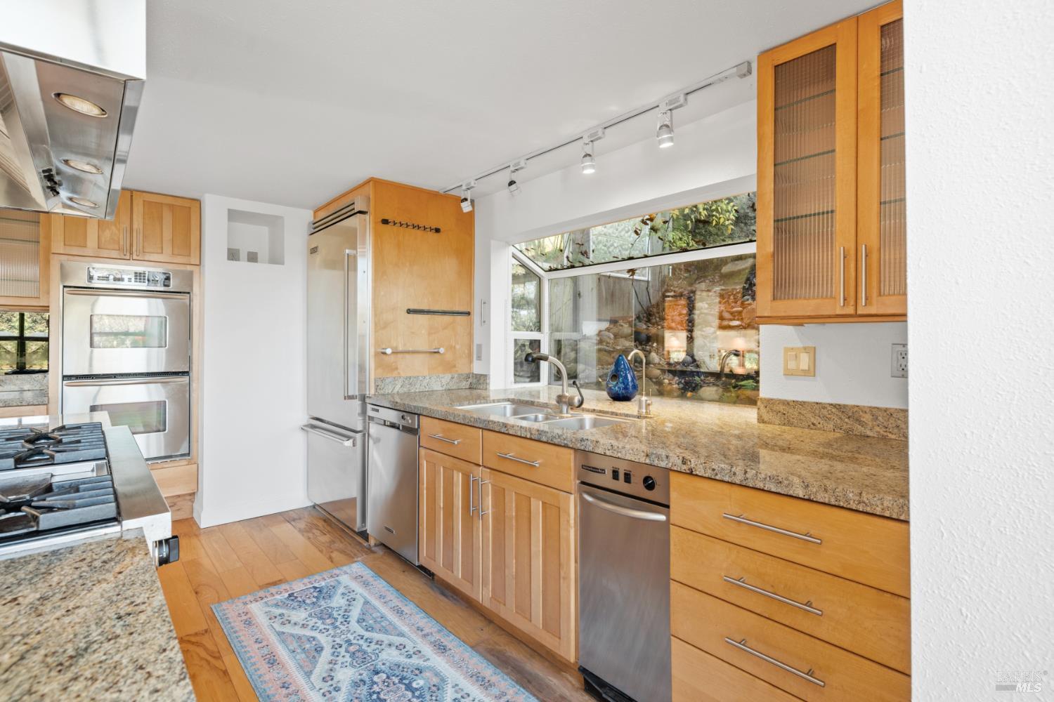 9105 Loch Haven Drive Santa Rosa, CA 95404 - Photo 51 of 62 a kitchen with stainless steel appliances granite countertop a sink stove and cabinets