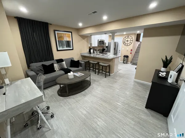 a living room with furniture and wooden floor