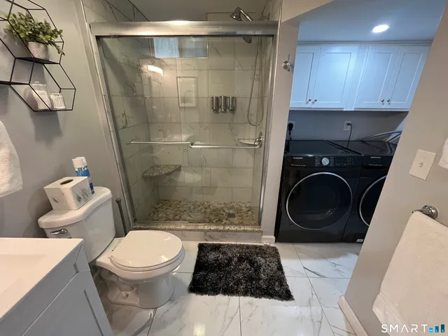 a bathroom with a toilet and a shower