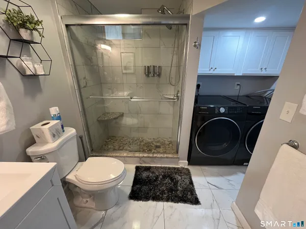 a bathroom with a toilet and a shower
