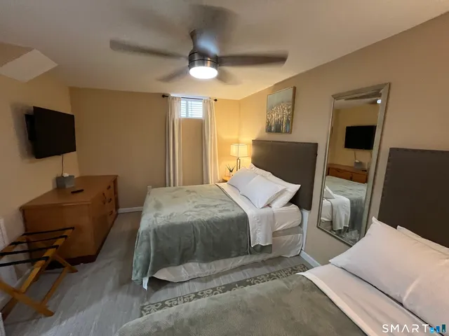 a bedroom with a bed and a flat screen tv