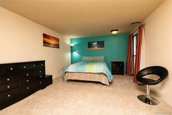 a bedroom with a bed and a chair