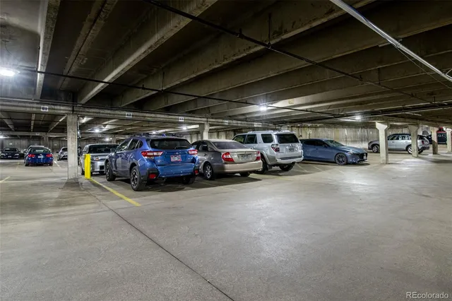 a view of parking garage with cars