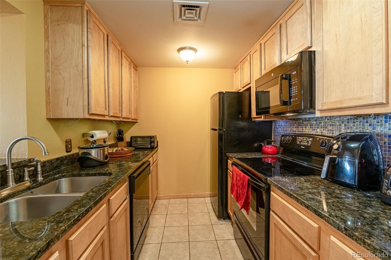 800 North Pearl Street, Unit 403 Denver, CO 80203 - Photo 2 of 36 a kitchen with stainless steel appliances granite countertop a sink stove and refrigerator