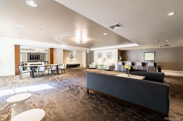 a living room with furniture and a dining room with kitchen view