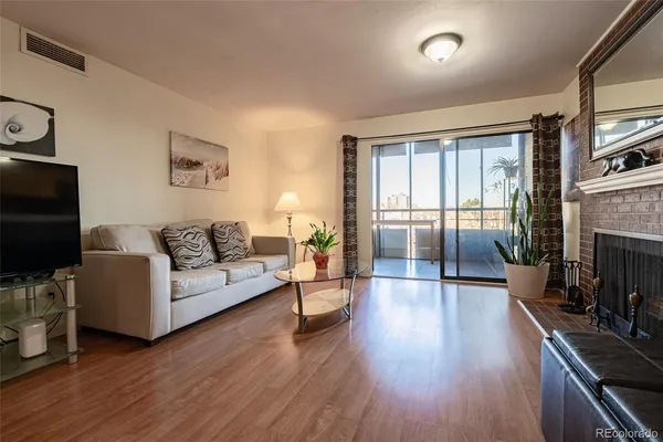 a living room with fireplace furniture and a flat screen tv