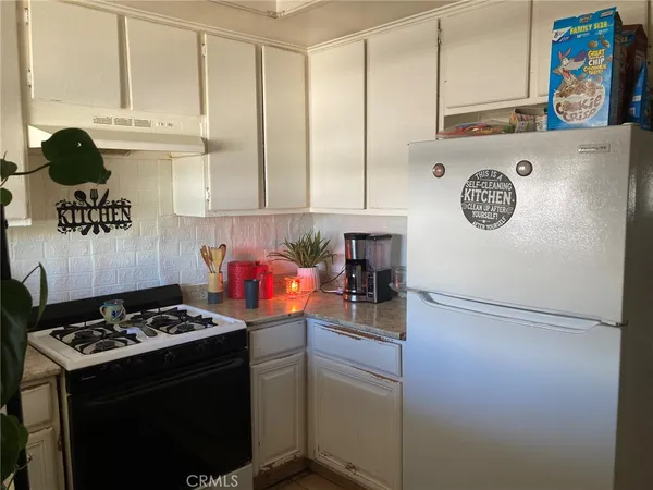 a kitchen with a stove and a refrigerator
