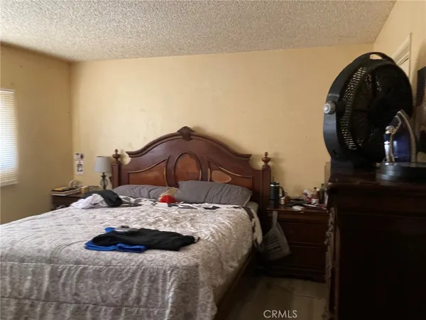 a bedroom with a bed and a mirror