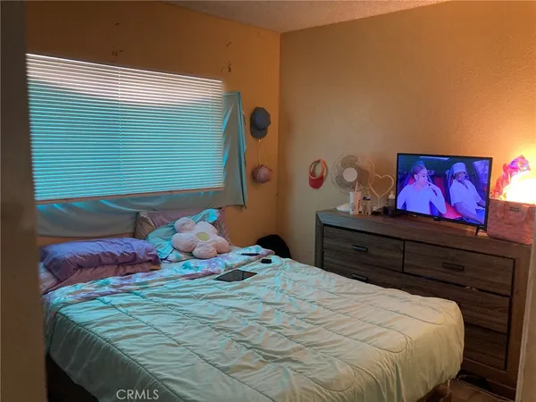 a bedroom with a bed and small cabinets