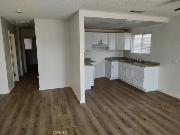 a kitchen with wooden floors and a sink