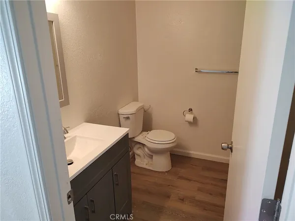 a white toilet sitting next to a white sink