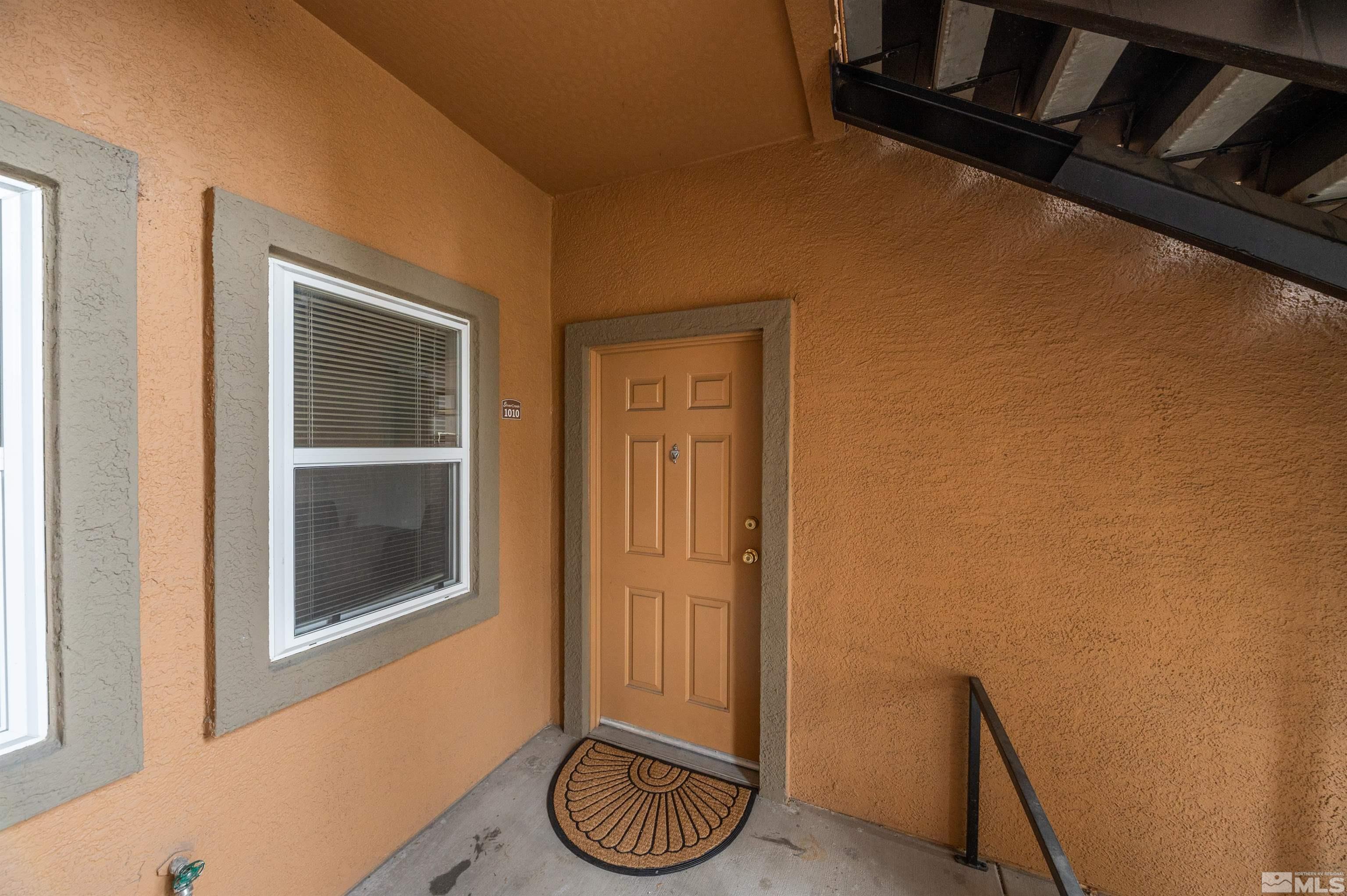 6850 Sharlands Avenue, Unit 1010 Reno, NV 89523 - Photo 3 of 28 a room with a wooden floor and a chair