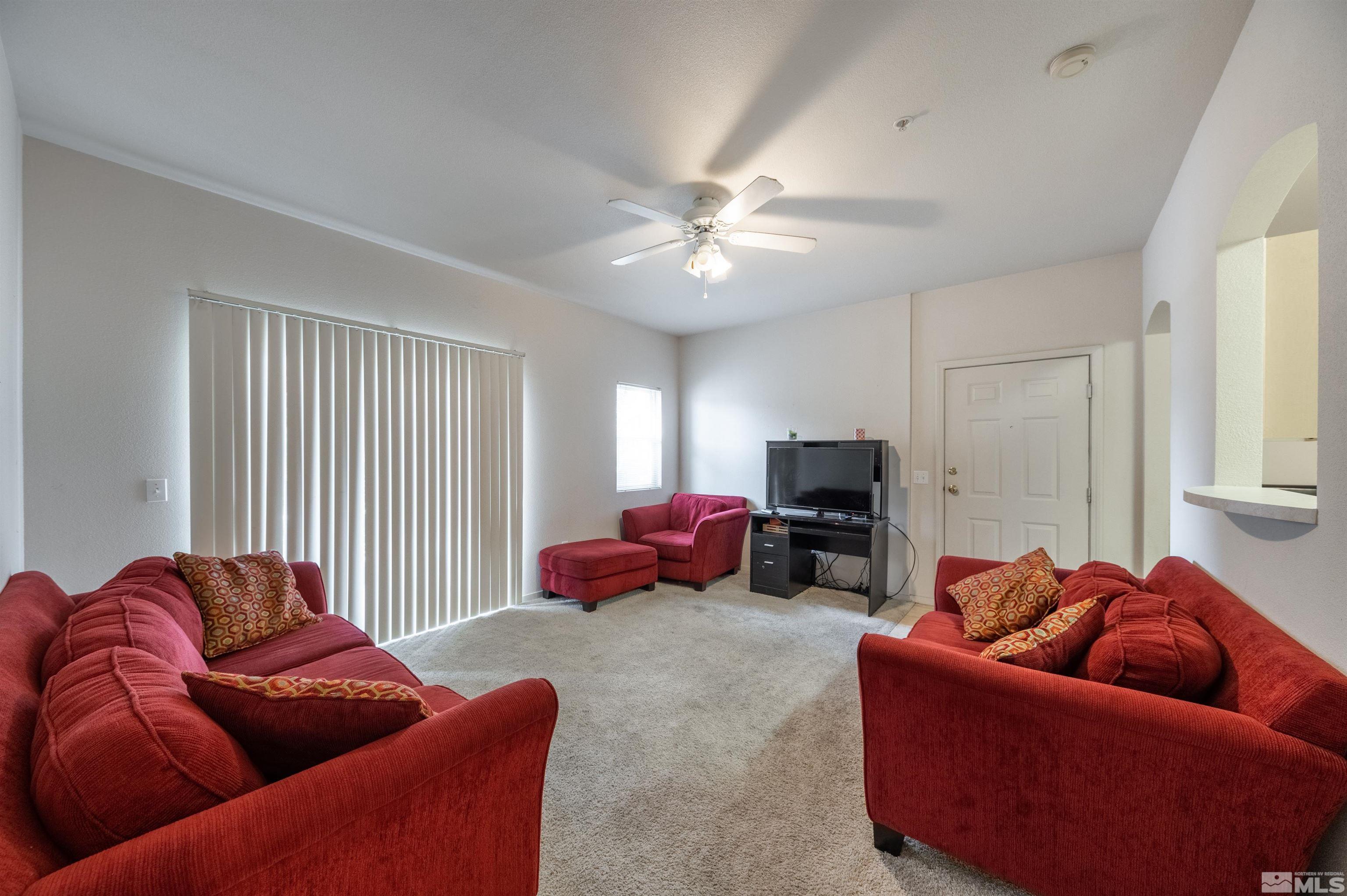 6850 Sharlands Avenue, Unit 1010 Reno, NV 89523 - Photo 4 of 28 a living room with furniture a ceiling fan and a window