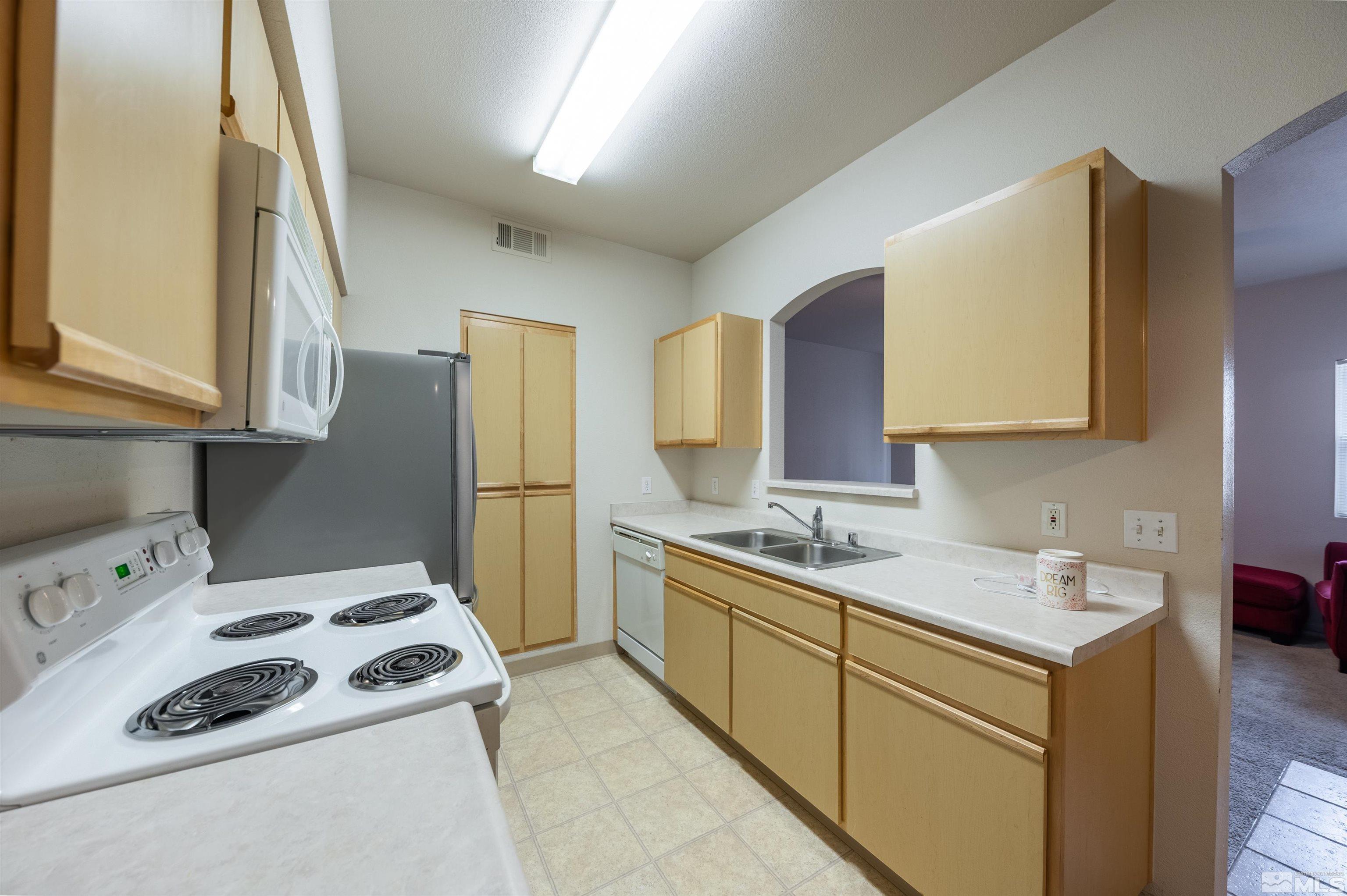 6850 Sharlands Avenue, Unit 1010 Reno, NV 89523 - Photo 8 of 28 a kitchen with a sink a stove and refrigerator
