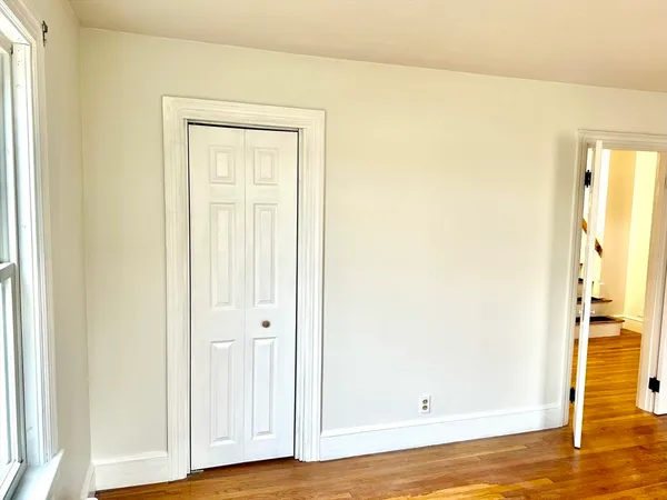 a view of a room with wooden floor