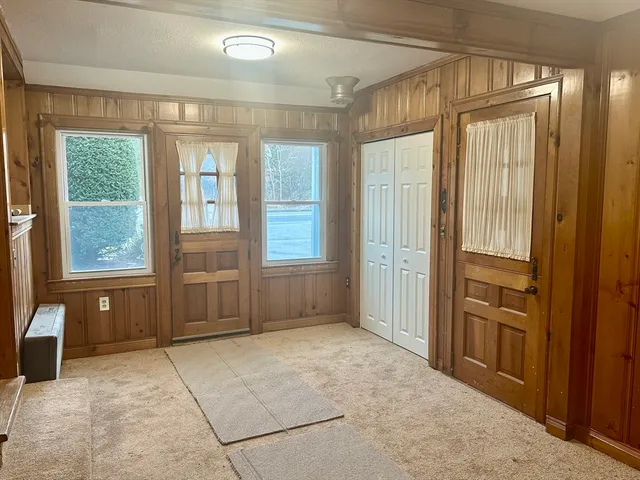 an empty room with windows and closet