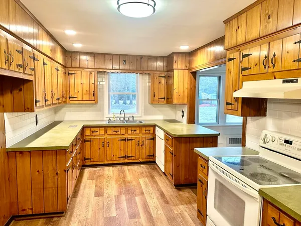 a kitchen with stainless steel appliances granite countertop a sink stove and cabinets