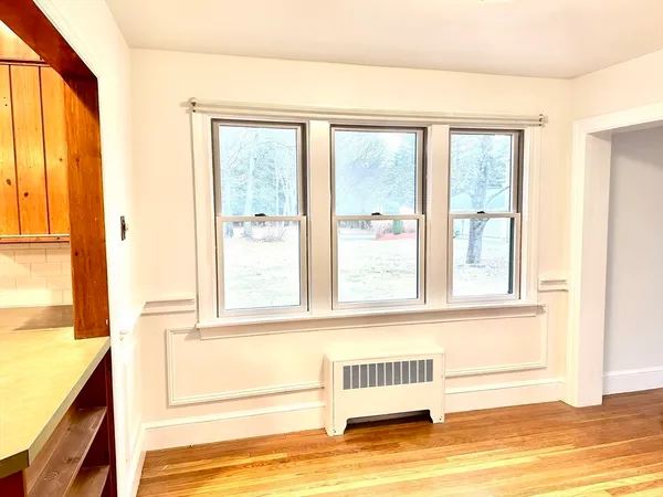 a view of a window and a room with wooden floor