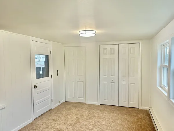 an empty room with closet area