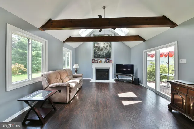 a living room with furniture a fireplace and a flat screen tv