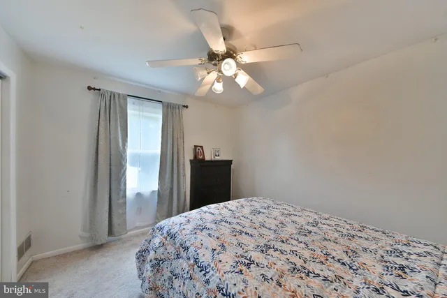 a spacious bedroom with a bed and a chair