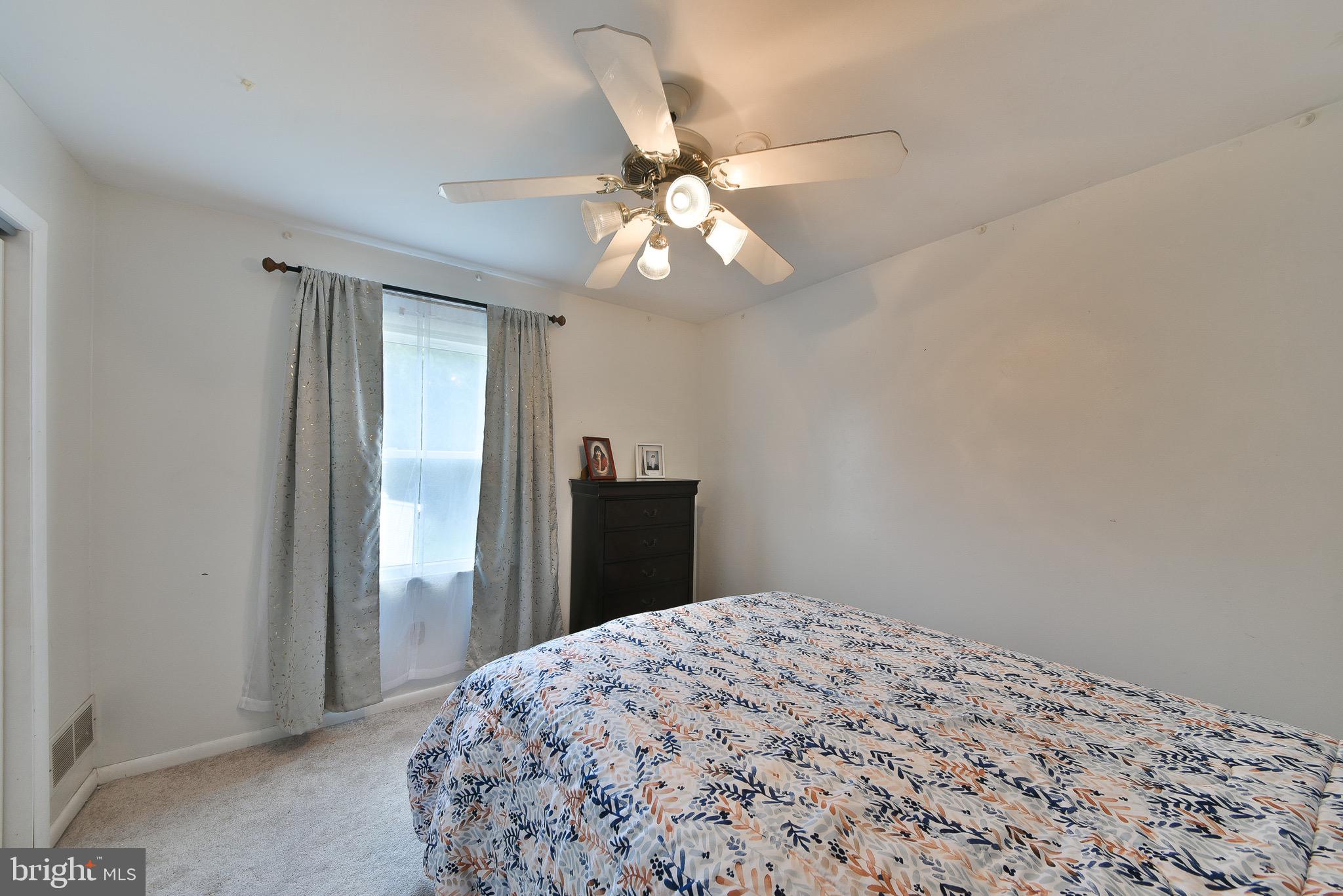 17 Ruhl Drive Perkasie, PA 18944 - Photo 30 of 41 a bedroom with a bed and a chandelier