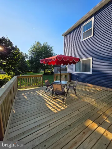a view of house with wooden floor and outdoor seating
