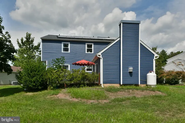 a front view of house with yard and trees