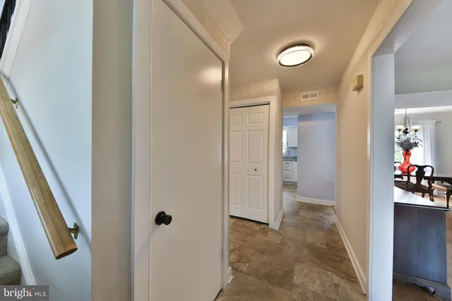 a view of a hallway with wooden shelves