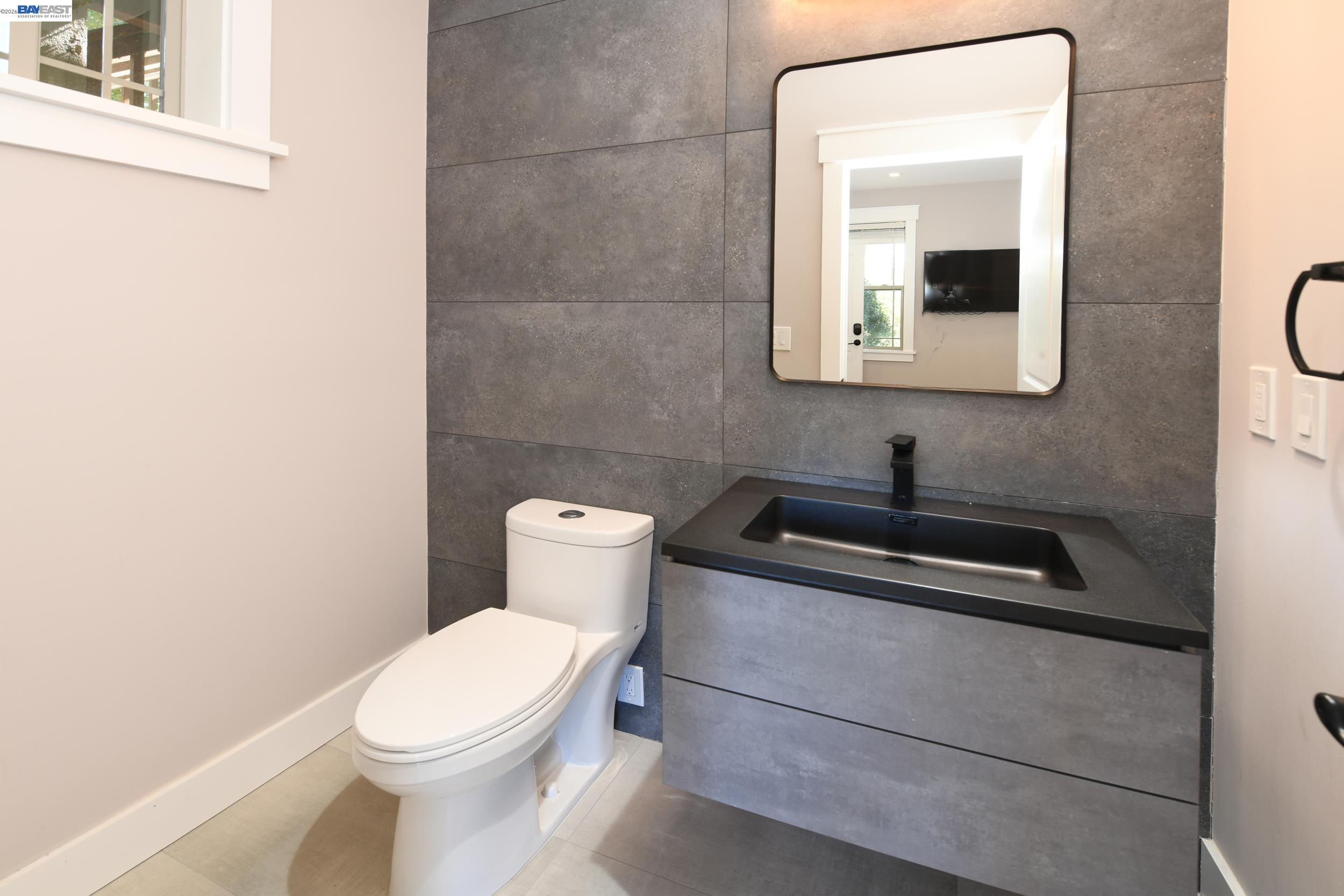 1516 Pleasant Hill Road Lafayette, CA 94549 - Photo 24 of 38 a bathroom with a toilet sink and mirror