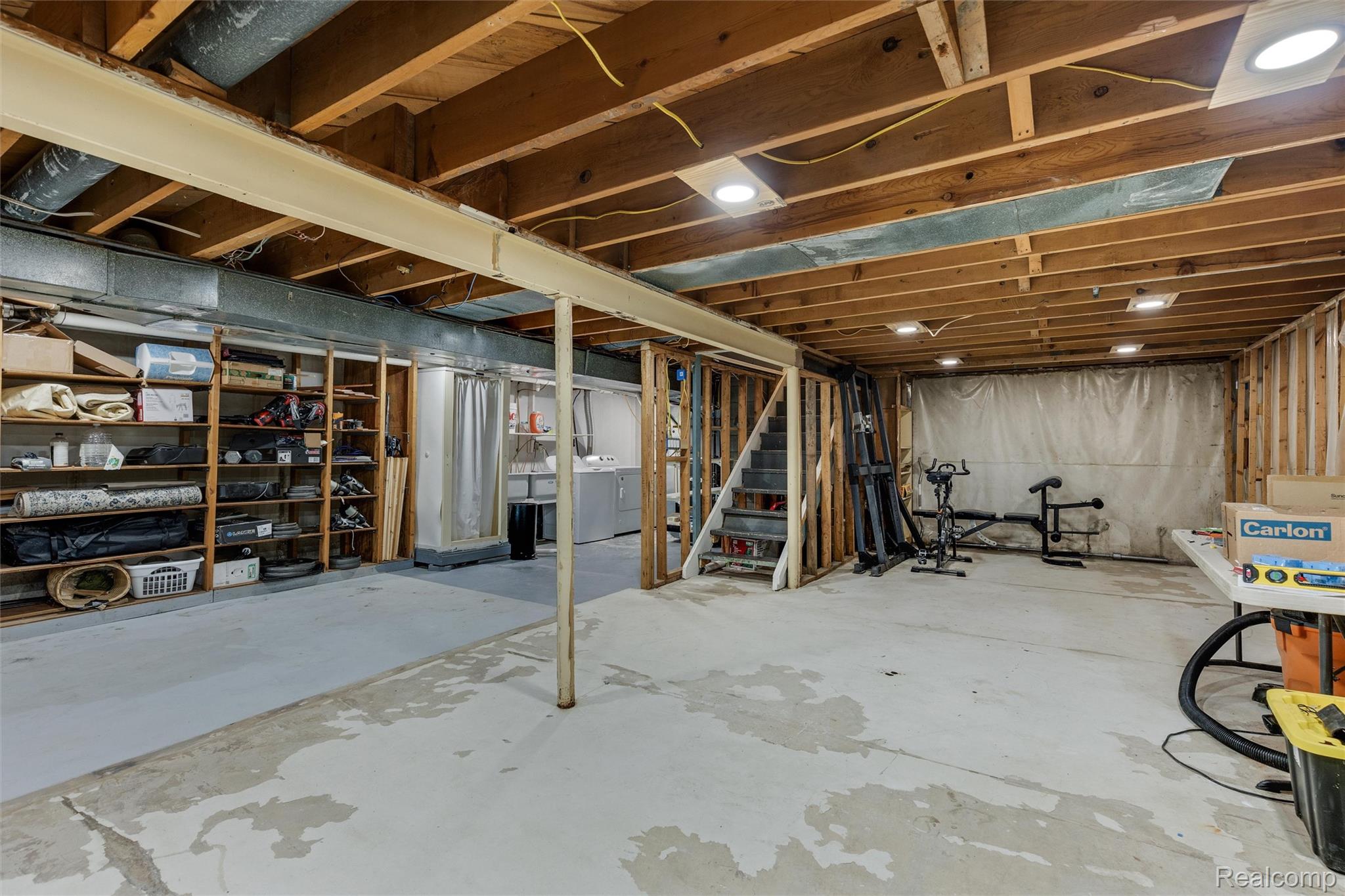 4497 Reid Road Swartz Creek, MI 48473 - Photo 22 of 31 Unfinished basement featuring exposed wood joists and support beams