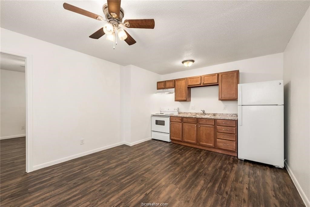 4309 College Main Street, Unit 6 Bryan, TX 77801 - Photo 2 of 8 a kitchen with stainless steel appliances a refrigerator and a stove top oven