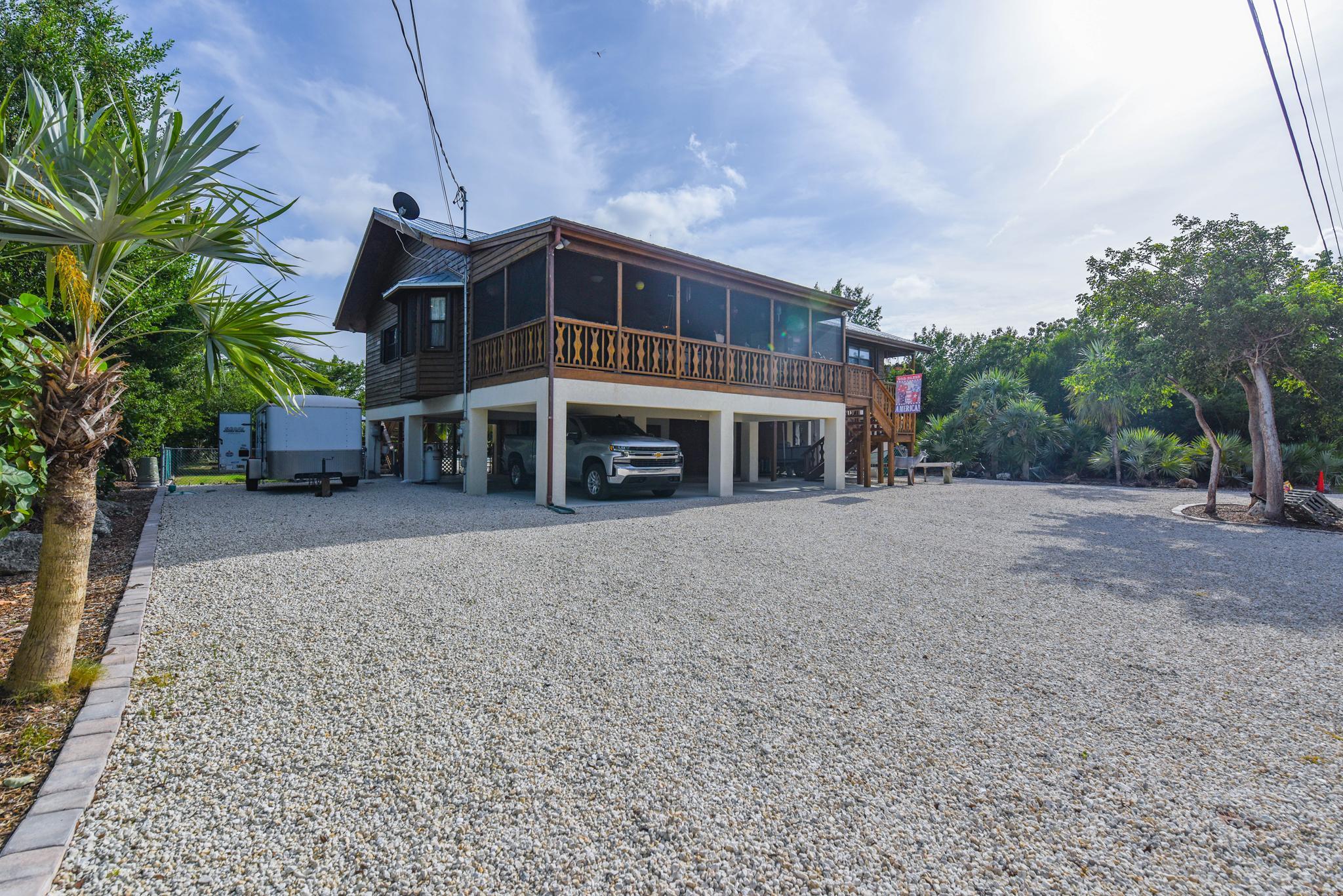 29430 Chickasaw Street Big Pine Key, FL 33043 - Photo 2 of 33 a view of a house with a yard and sitting area