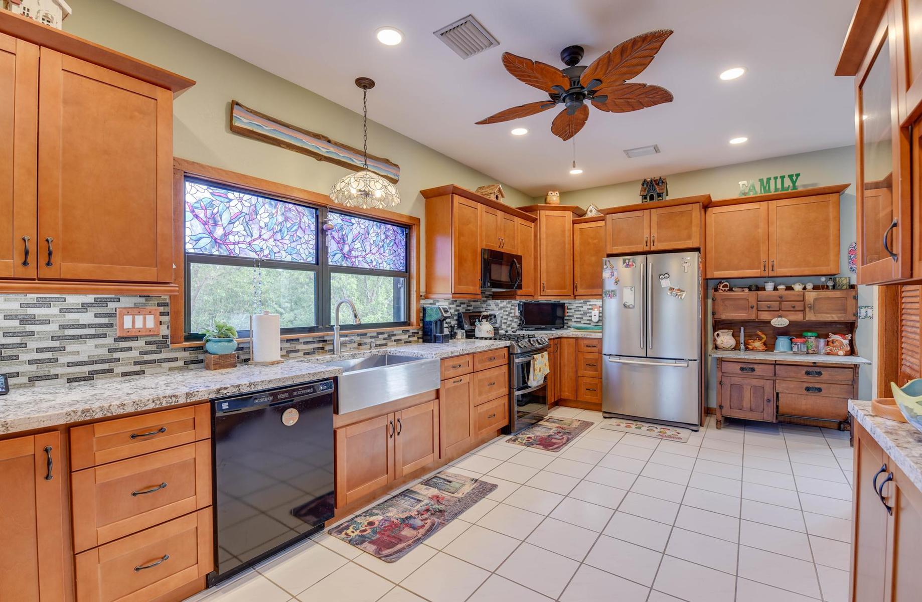 29430 Chickasaw Street Big Pine Key, FL 33043 - Photo 12 of 33 a kitchen with a sink appliances cabinets and furniture