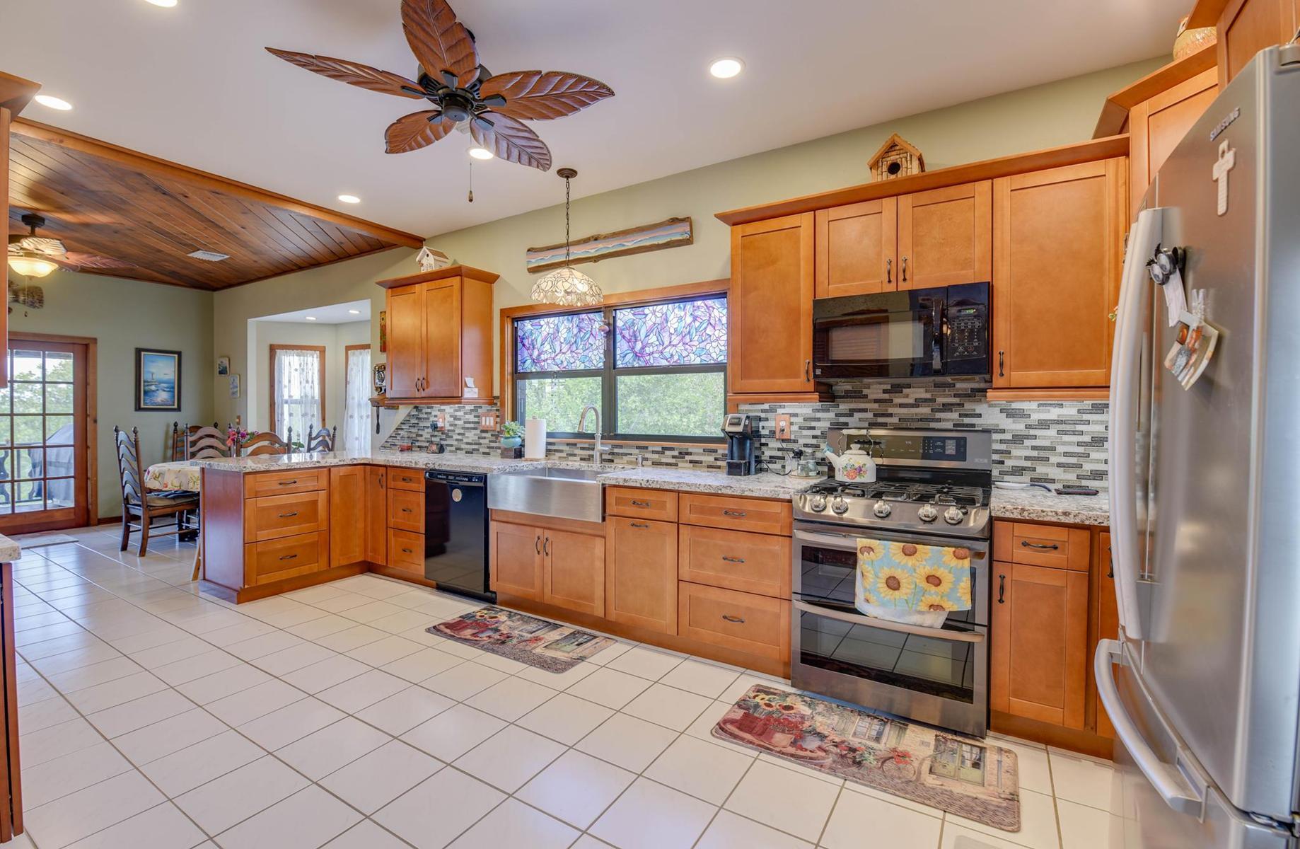 29430 Chickasaw Street Big Pine Key, FL 33043 - Photo 13 of 33 a kitchen with stainless steel appliances kitchen island granite countertop a sink and cabinets