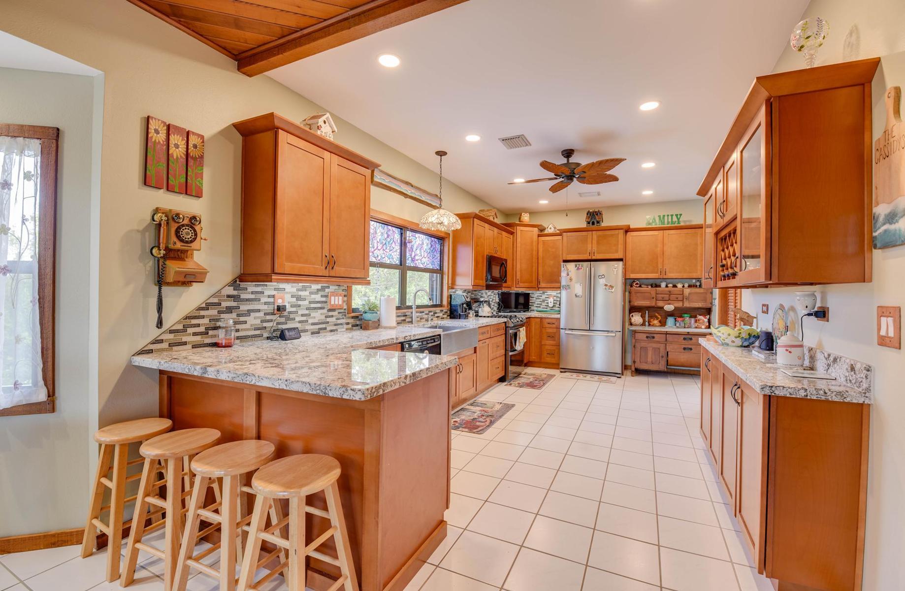 29430 Chickasaw Street Big Pine Key, FL 33043 - Photo 14 of 33 a kitchen with stainless steel appliances kitchen island granite countertop a sink and cabinets
