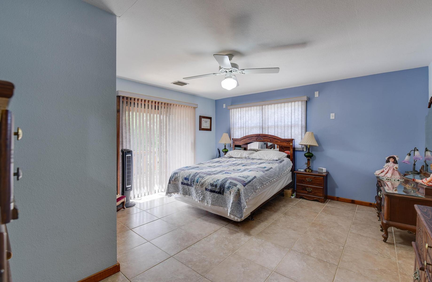 29430 Chickasaw Street Big Pine Key, FL 33043 - Photo 18 of 33 a bedroom with a bed and a chandelier