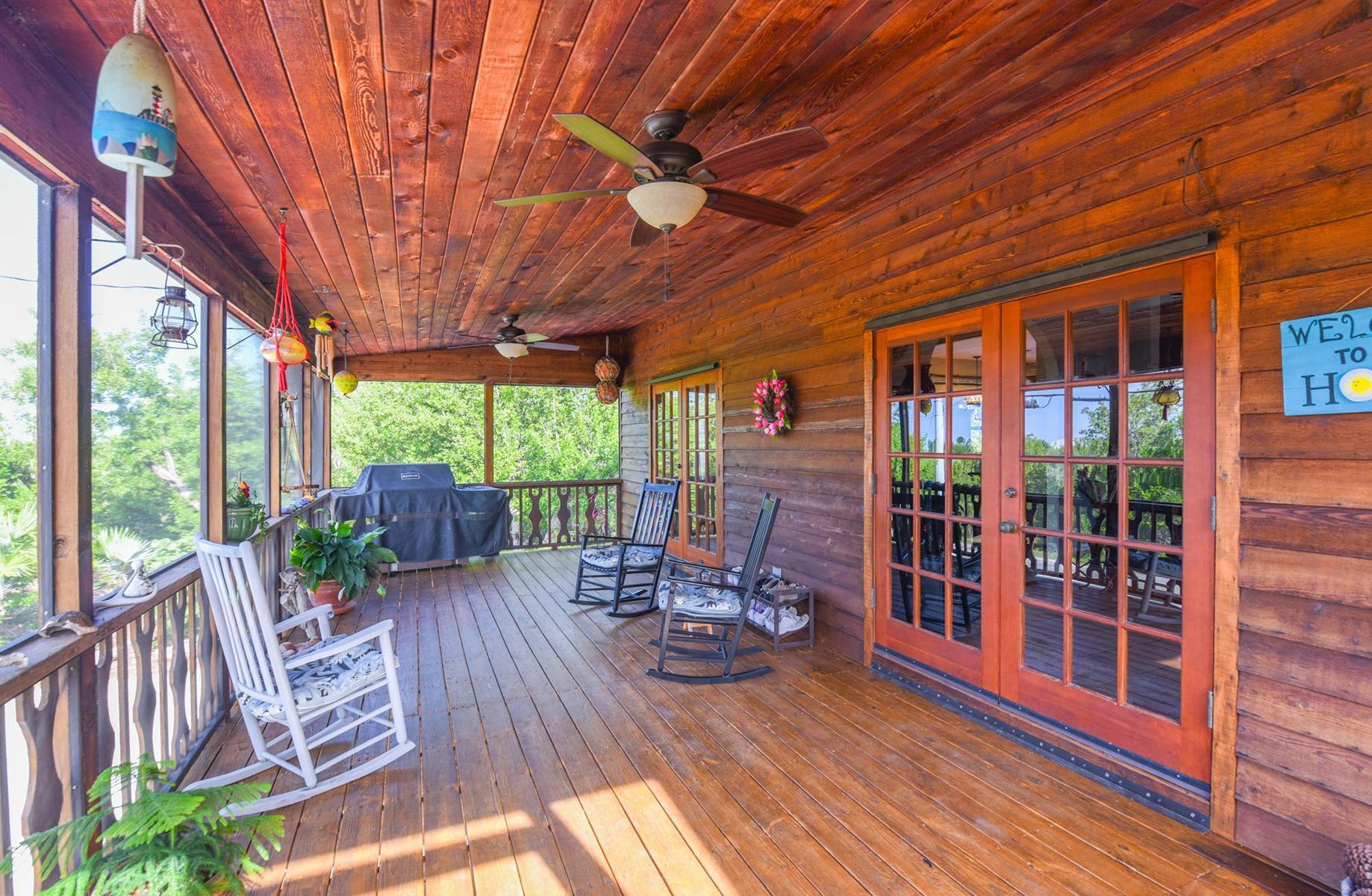 29430 Chickasaw Street Big Pine Key, FL 33043 - Photo 26 of 33 a view of a patio with table and chairs and wooden floor
