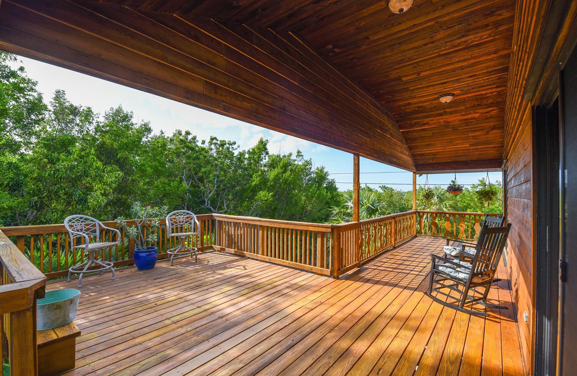 29430 Chickasaw Street Big Pine Key, FL 33043 - Photo 30 of 33 a view of deck with table and chairs and wooden floor