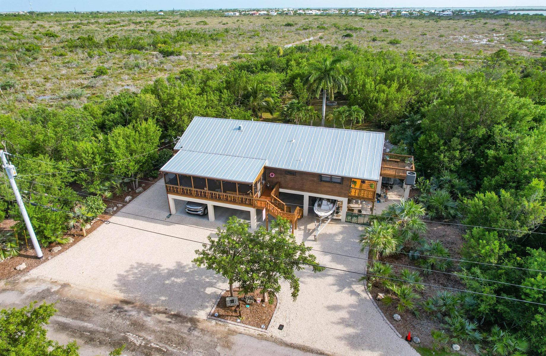 29430 Chickasaw Street Big Pine Key, FL 33043 - Photo 5 of 33 an aerial view of a house with yard and mountain view in back