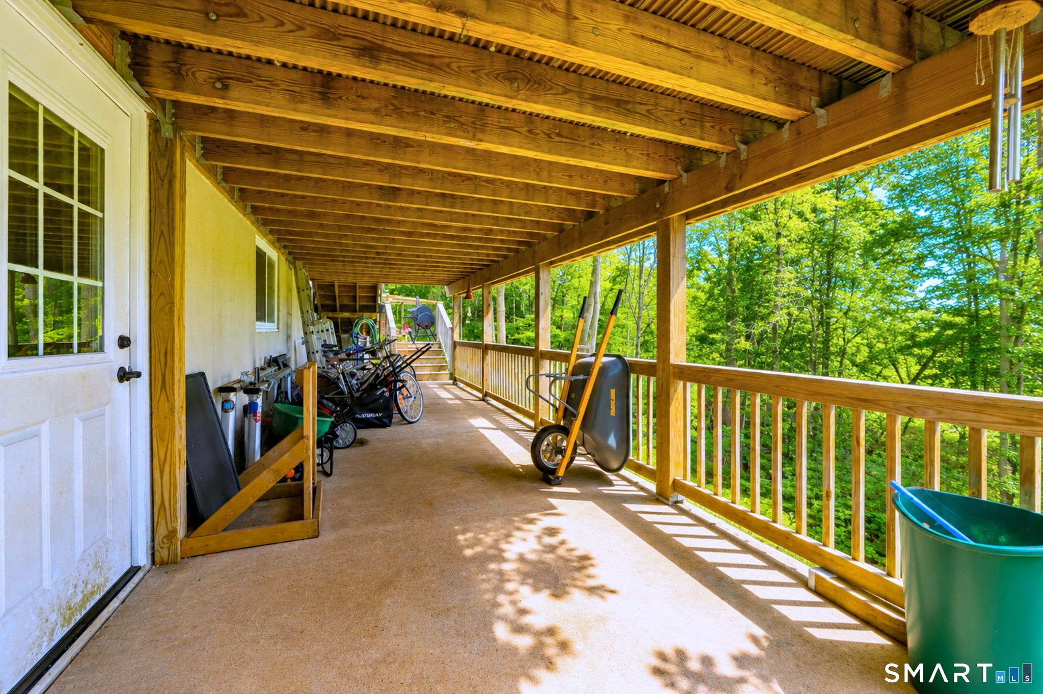 265 Shelter Rock Road Fairfield, CT 06825 - Photo 29 of 32 The walkout basement has a door which leads to a large covered area below the deck, providing additional space for storage or entertaining.