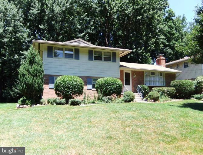 a view of house with yard and green space