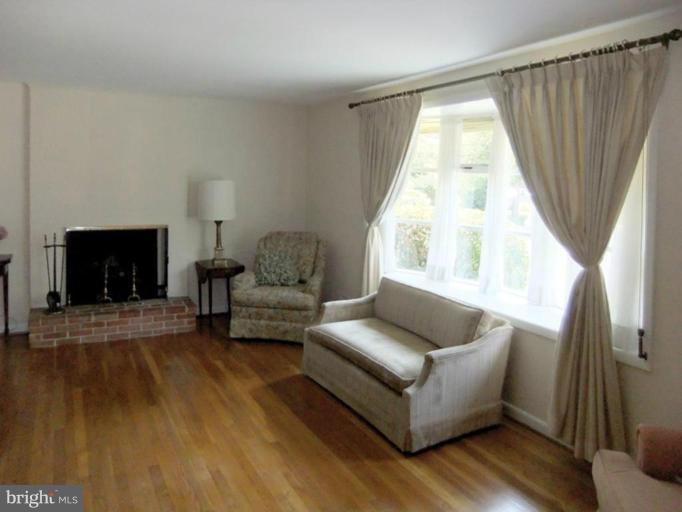 6411 Earlham Drive Bethesda, MD 20817 - Photo 3 of 16 a living room with furniture and a fireplace