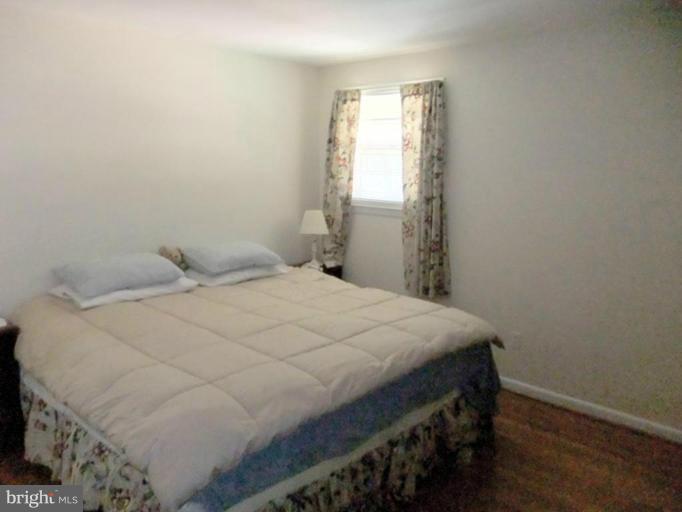6411 Earlham Drive Bethesda, MD 20817 - Photo 10 of 16 a bedroom with a bed and a window