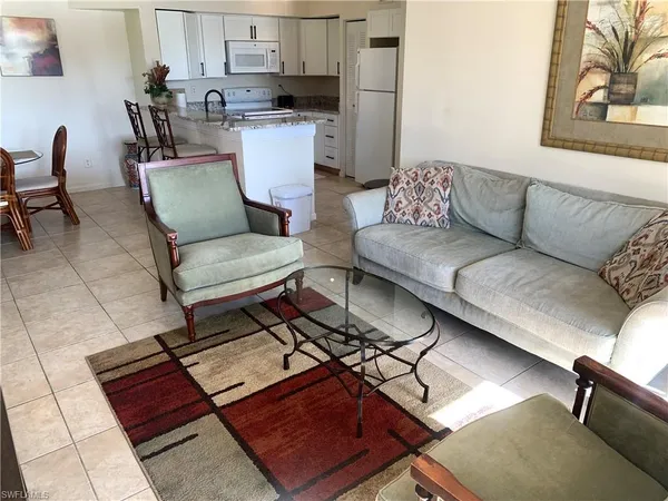 a living room with furniture and a rug