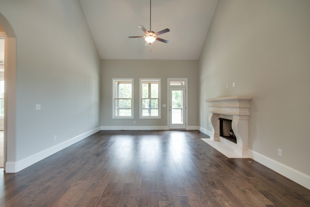 938 Hunters Lane Springfield, TN 37172 - Photo 11 of 29 an empty room with wooden floor fireplace and windows