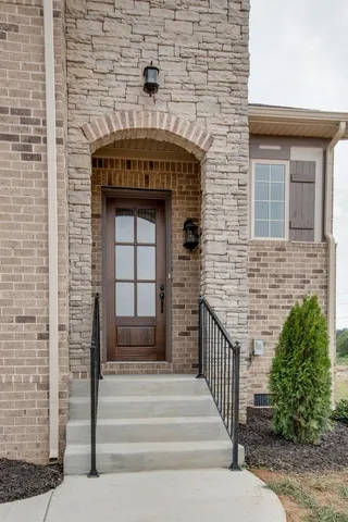 a front view of a house with stairs