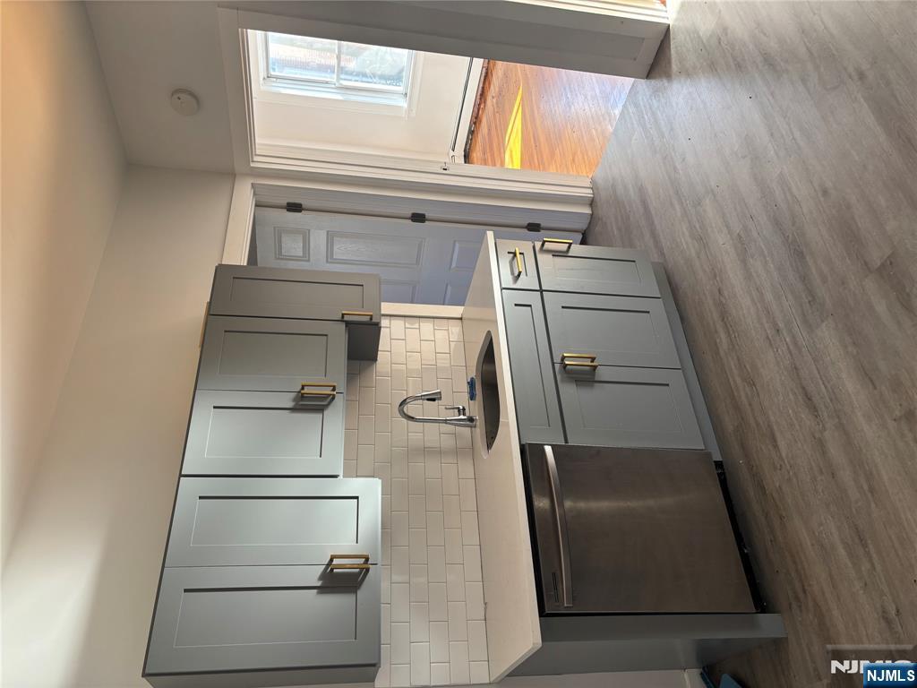 86 Center Street, Unit 3F Clifton, NJ 07011 - Photo 2 of 8 a kitchen with stainless steel appliances granite countertop a sink stove and cabinets