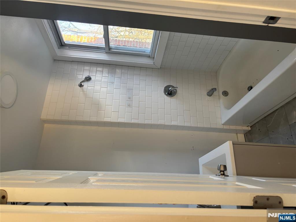 86 Center Street, Unit 3F Clifton, NJ 07011 - Photo 5 of 8 a bathroom with a bathtub sink and shower